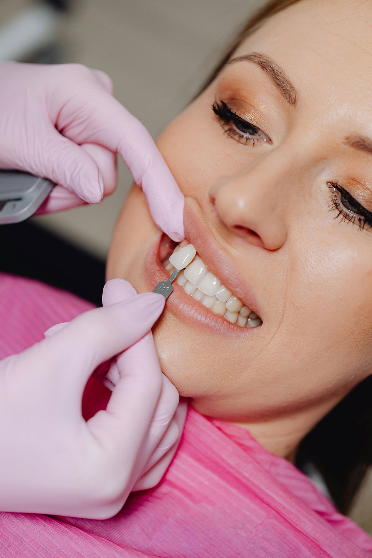 Crown being placed in a woman's mouth